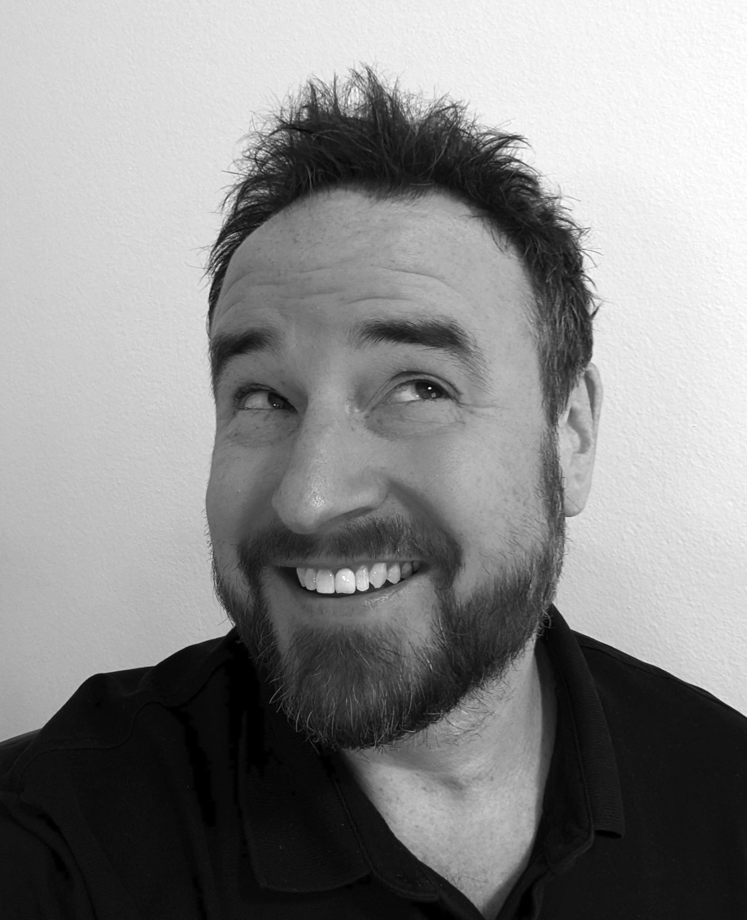 Photo of Dirk as he cheekily grins and looks to his top left